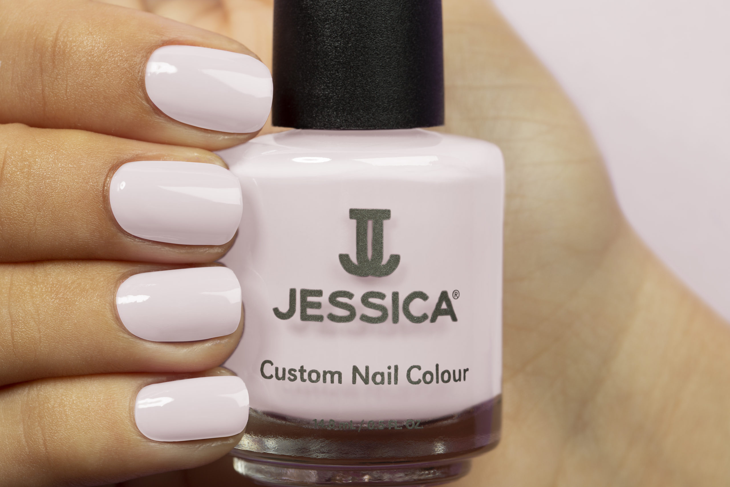 Manicured hands wearing and holding Cheeky Custom Colour Nail Polish