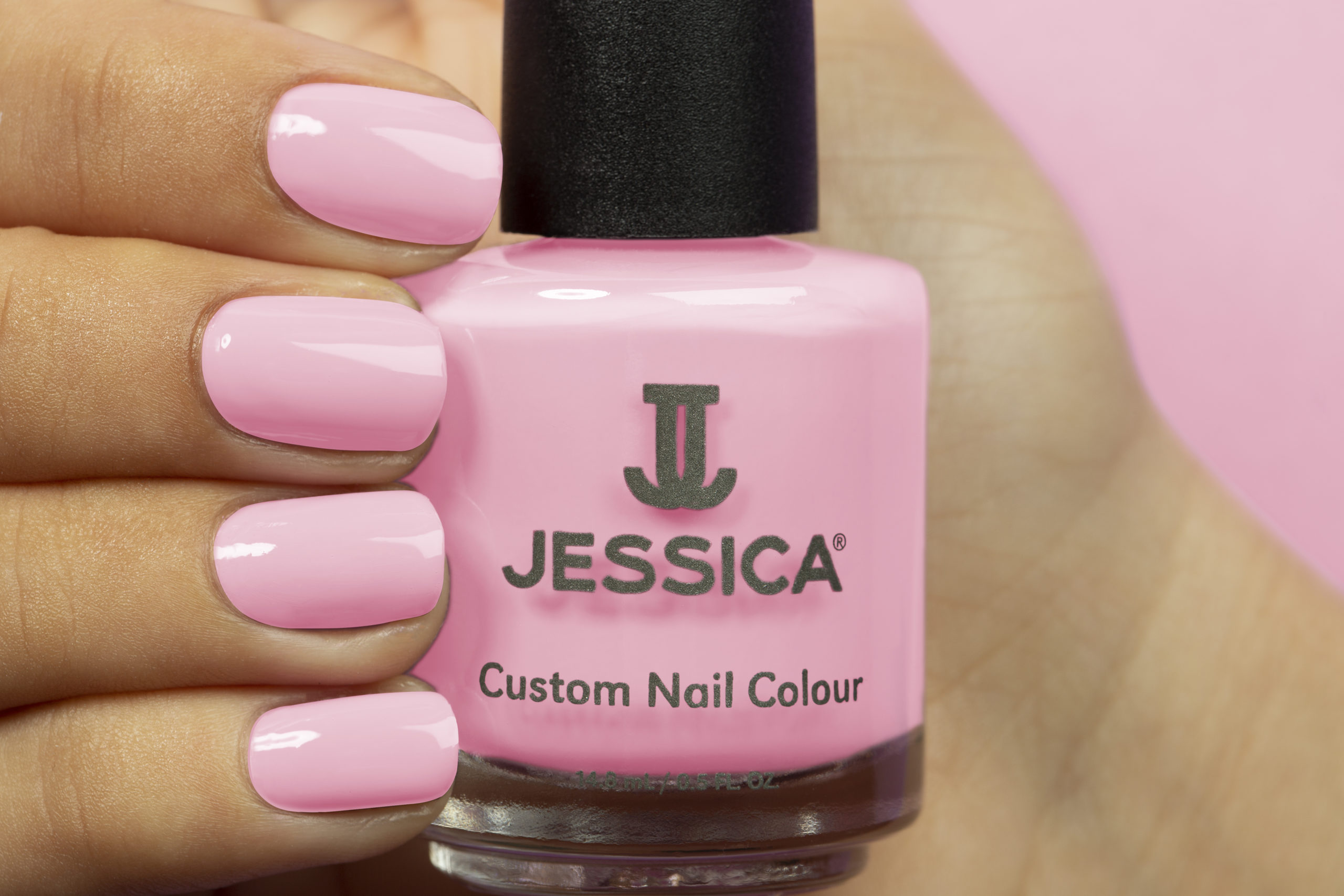 Manicured hands wearing and holding Pinkies Up Custom Colour Nail Polish