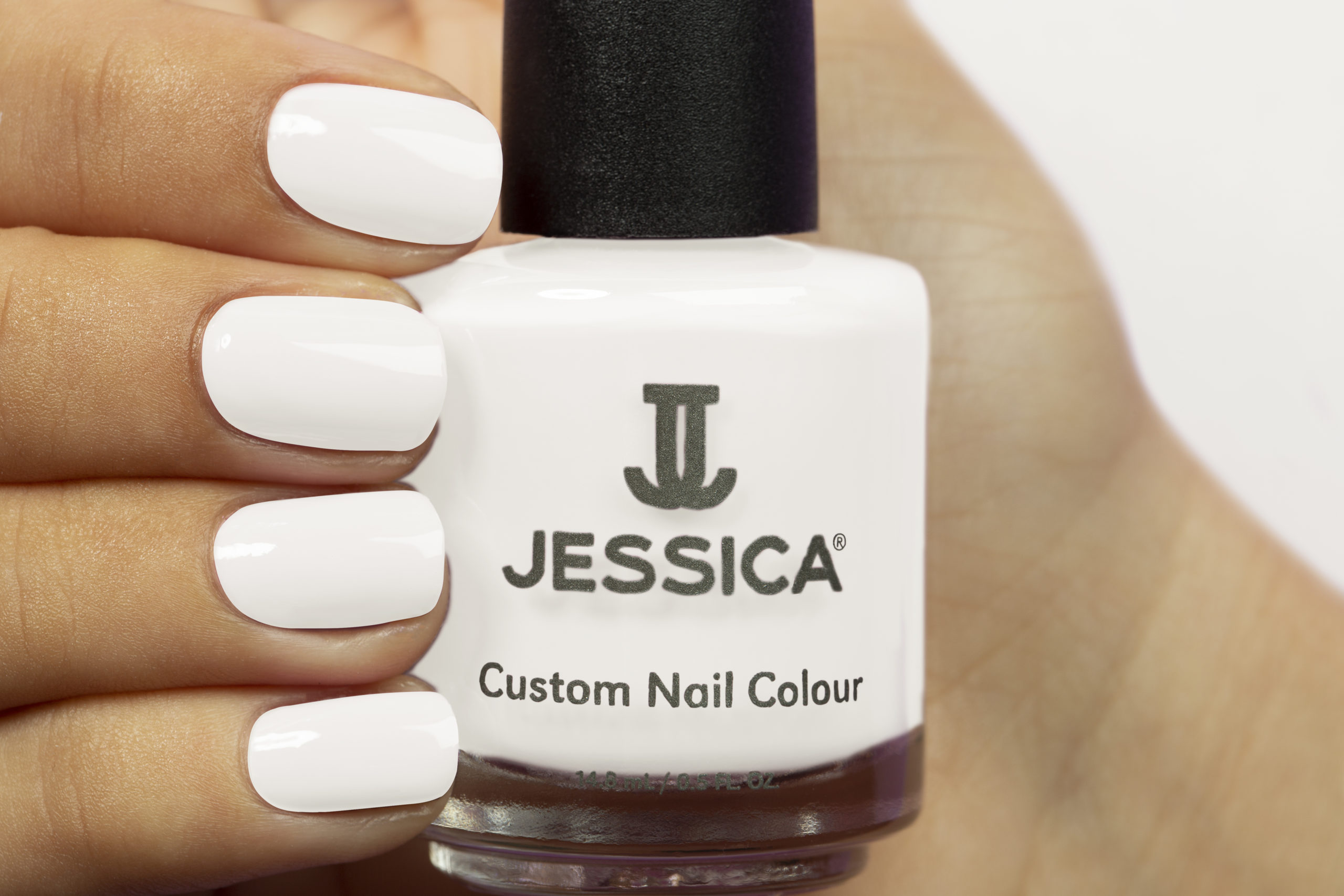 Manicured hands wearing and holding Lavish Custom Colour Nail Polish
