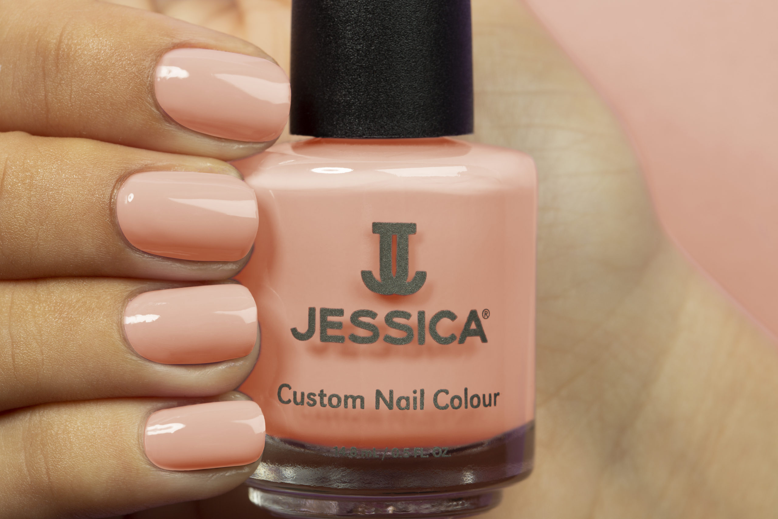 Manicured hands wearing and holding Pumpkin Spice Custom Colour Nail Polish