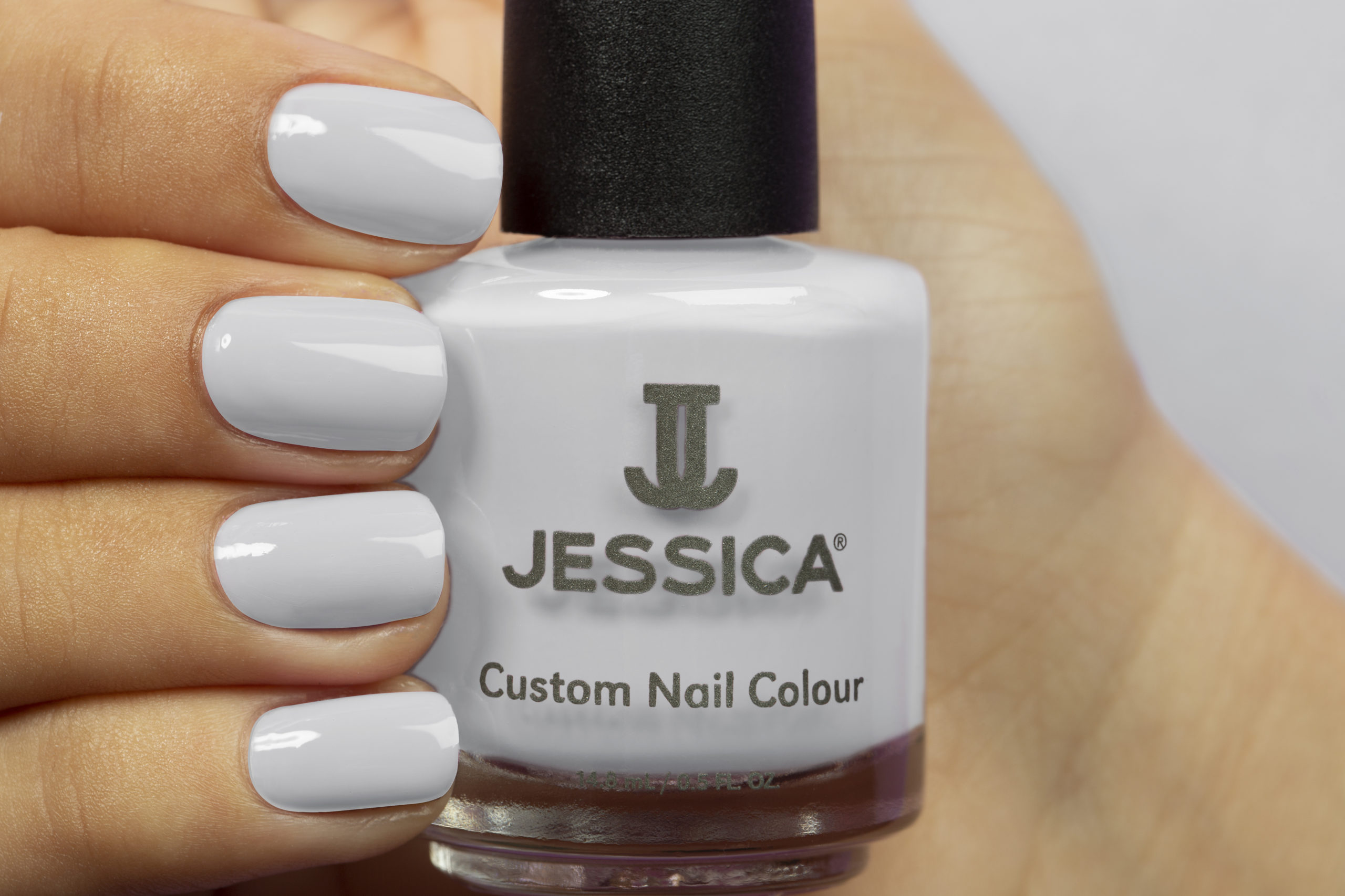 Manicured hands wearing and holding Earl Grey Custom Colour Nail Polish