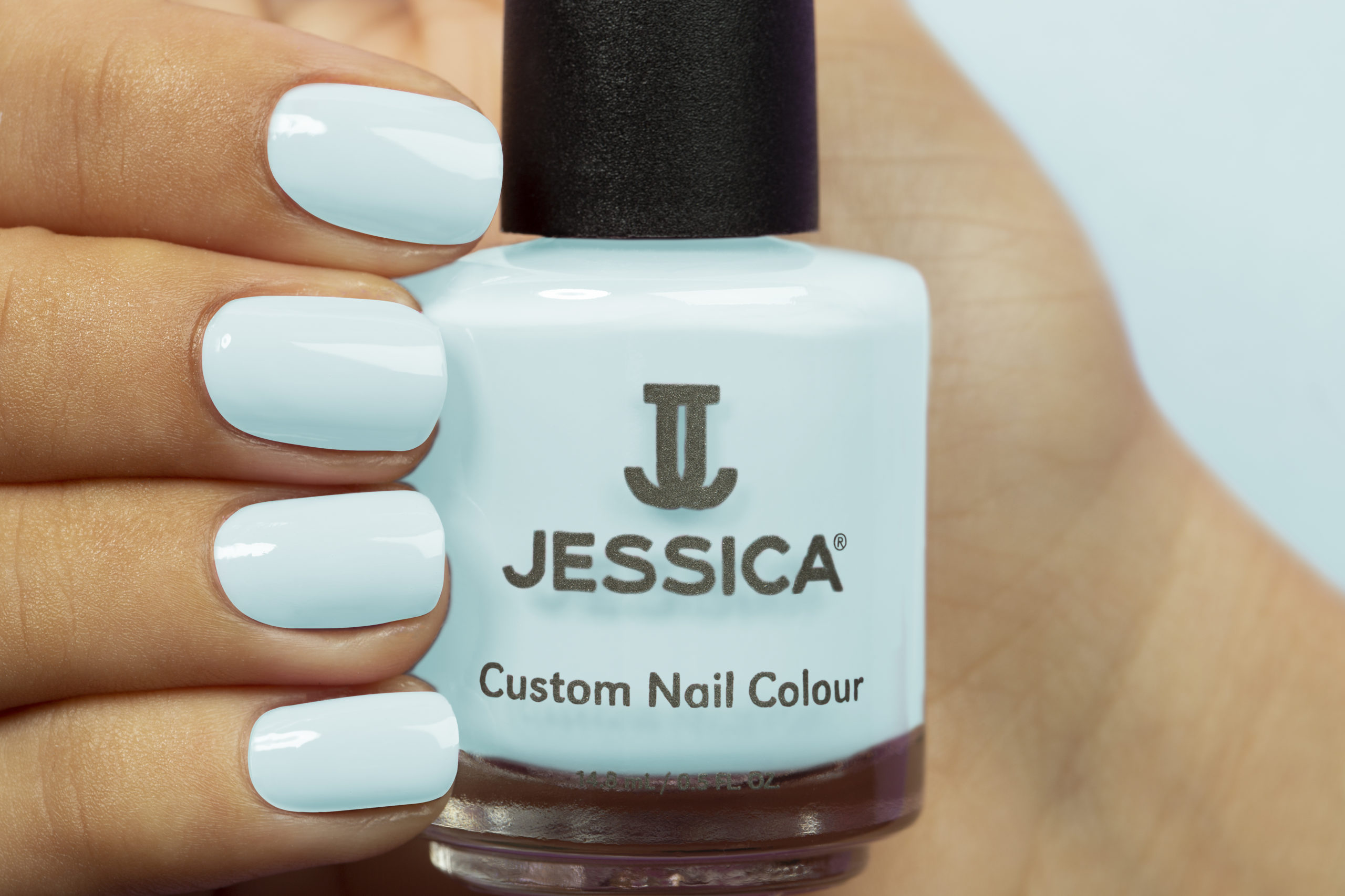 Manicured hands wearing and holding Cool In The Pool Custom Colour Nail Polish