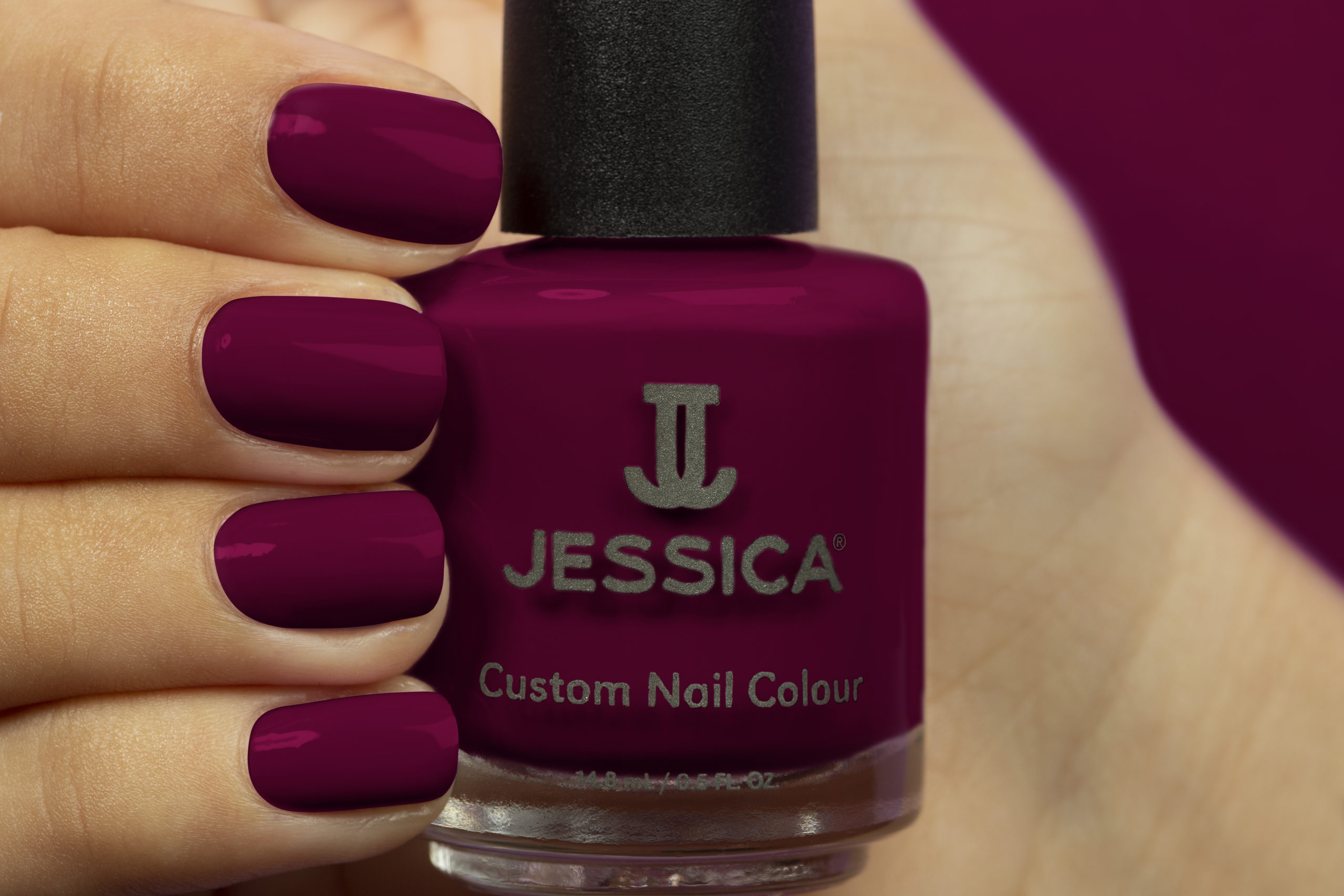 Manicured hands wearing and holding Sexy Siren Custom Colour Nail Polish