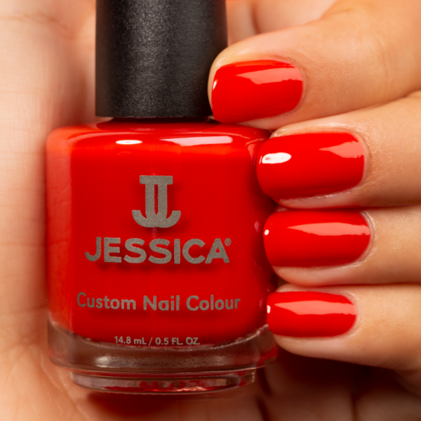 Manicured hands wearing and holding Lava Flow Custom Colour Nail Polish