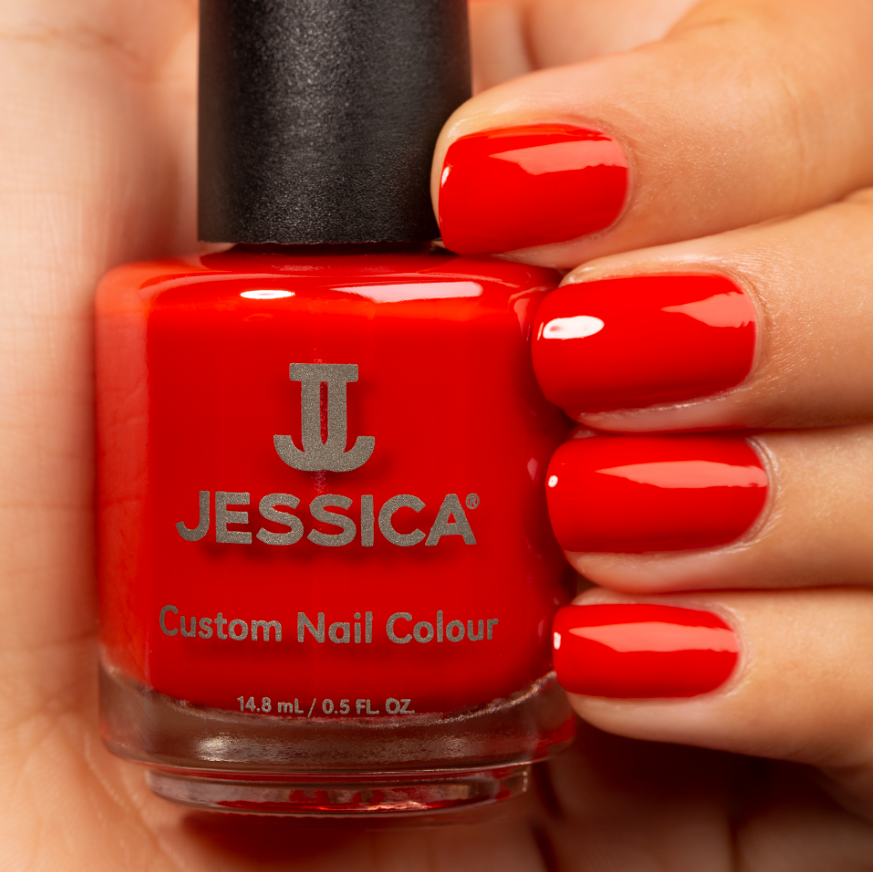 Manicured hands wearing and holding Lava Flow Custom Colour Nail Polish